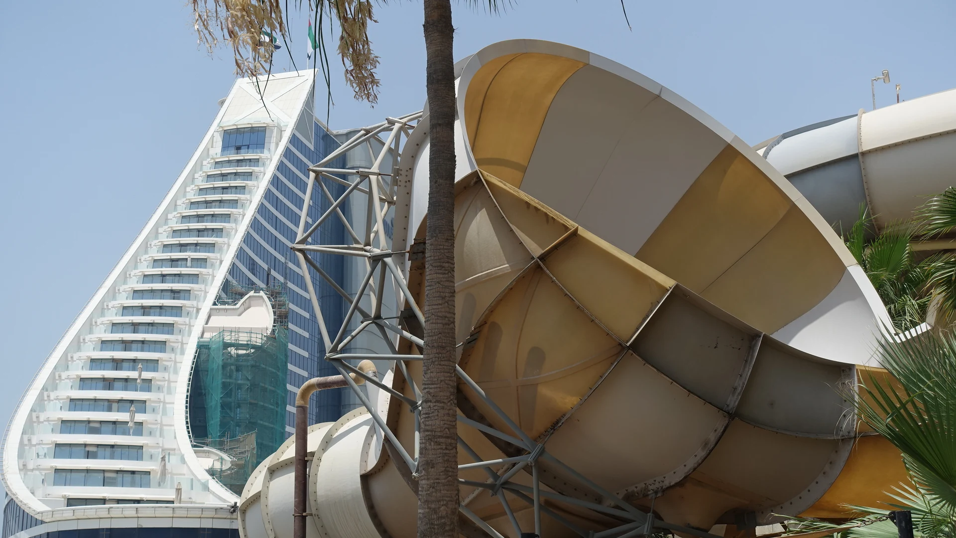 Jumeirah Beach Hotel's wave-shaped tower rising behind the Wild Wadi Water Park slides in Dubai