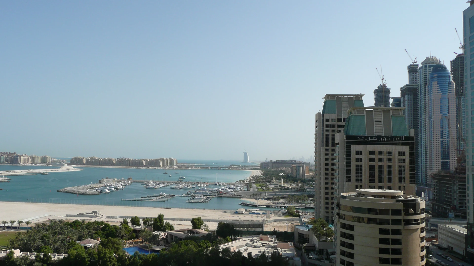 Dubai Marina skyline with the Burj Al Arab visible across the water in the distance